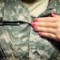 Meredith Shumrick, an Ohio University Army ROTC candidate, puts on her Class A uniform while getting ready for school. Meredith Shumrick, an Ohio University Army ROTC candidate, puts on her Class A uniform while getting ready for school.