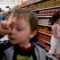Shayla picks up some bread at Walmart with her younger brother Jacob in the cart while her mother Christy gets a haircut.