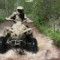 Jeffrey Martin, of Dover, Ohio, splashes through a creek at the bottom of a trail.